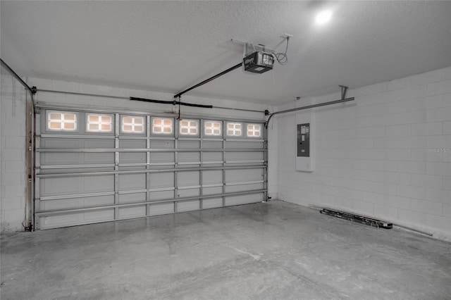 garage with a garage door opener and electric panel