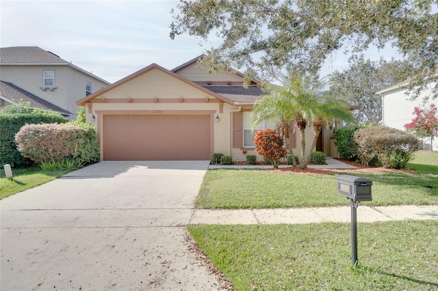 view of front of home with a garage and a front lawn