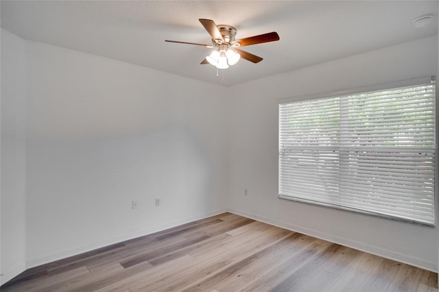 empty room with light hardwood / wood-style flooring and ceiling fan