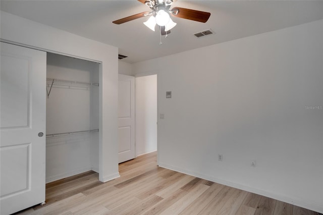 unfurnished bedroom with light hardwood / wood-style floors, a closet, and ceiling fan