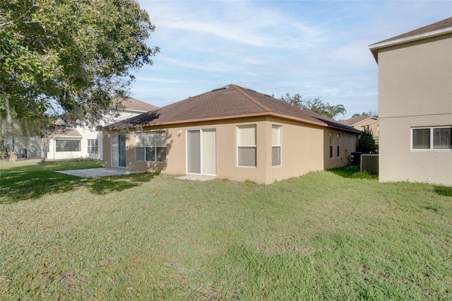 rear view of property featuring a patio and a lawn