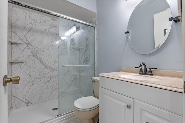 bathroom featuring vanity, toilet, and a shower with shower door