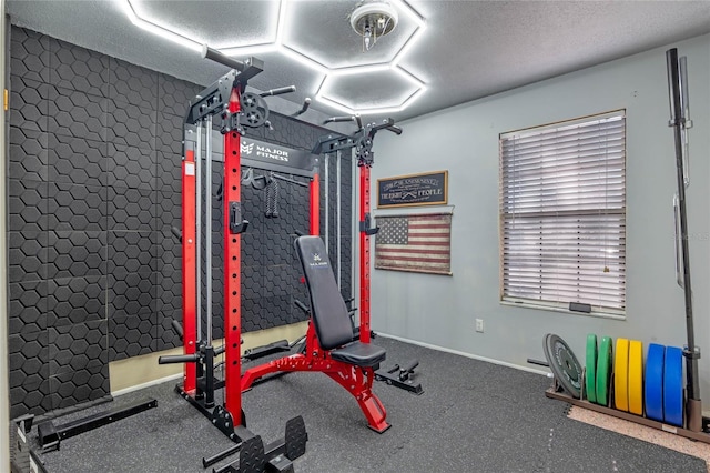 workout area featuring a textured ceiling