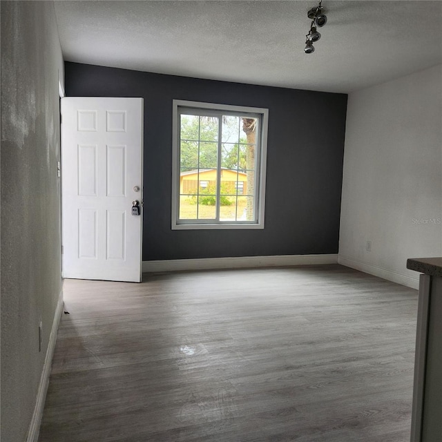 unfurnished room with hardwood / wood-style floors