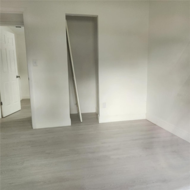 unfurnished room with light hardwood / wood-style floors