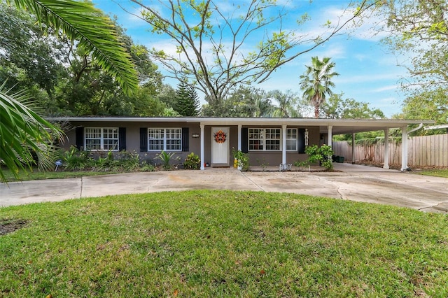 ranch-style house featuring a front lawn and a carport