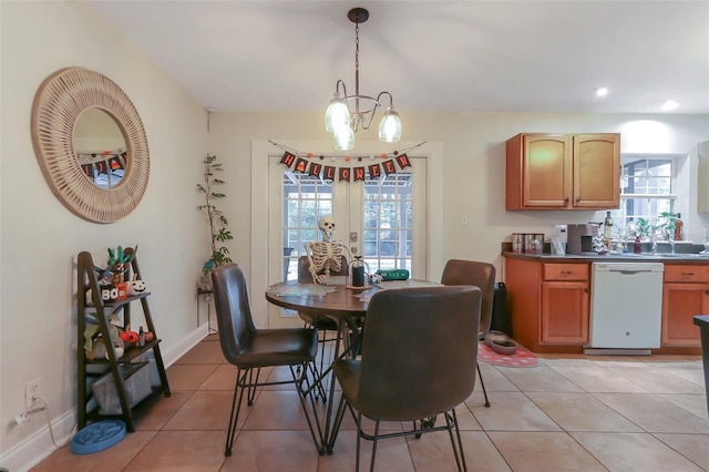 tiled dining room featuring french doors and an inviting chandelier