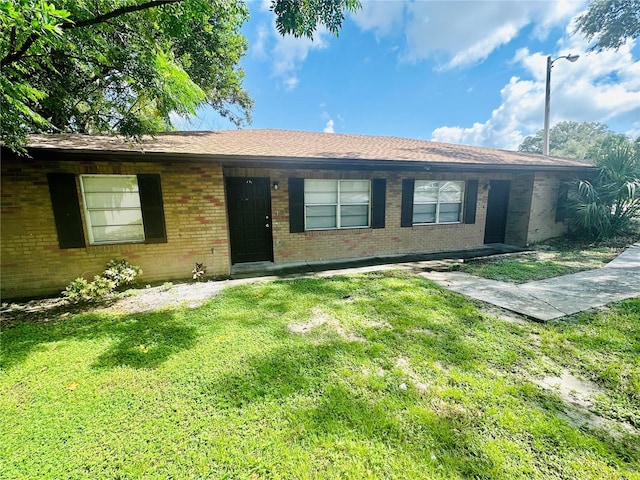 ranch-style home with a front lawn