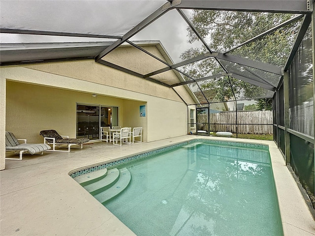 view of swimming pool with a lanai and a patio