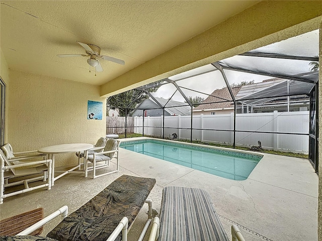 view of pool with a lanai, a patio area, and ceiling fan