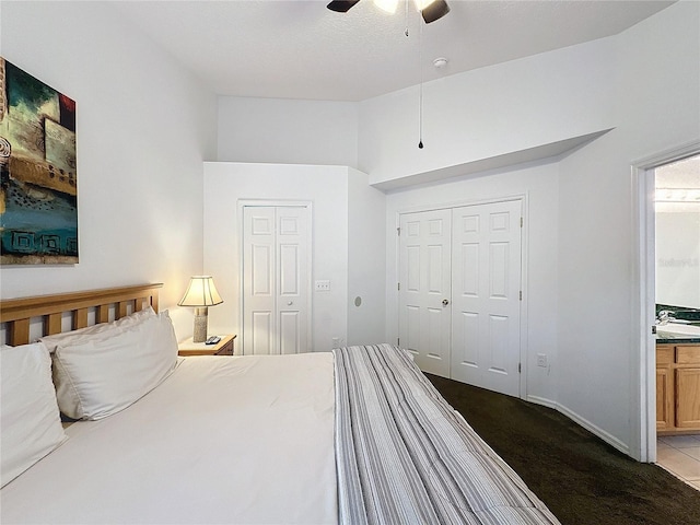 carpeted bedroom with ceiling fan and ensuite bathroom