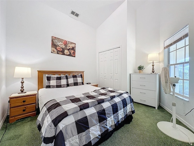 bedroom featuring carpet flooring, high vaulted ceiling, and a closet