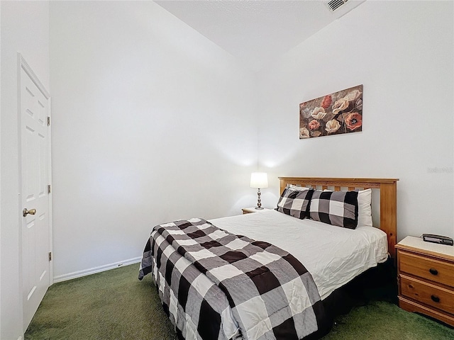 bedroom featuring dark carpet and lofted ceiling