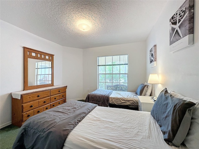 bedroom featuring carpet floors and a textured ceiling