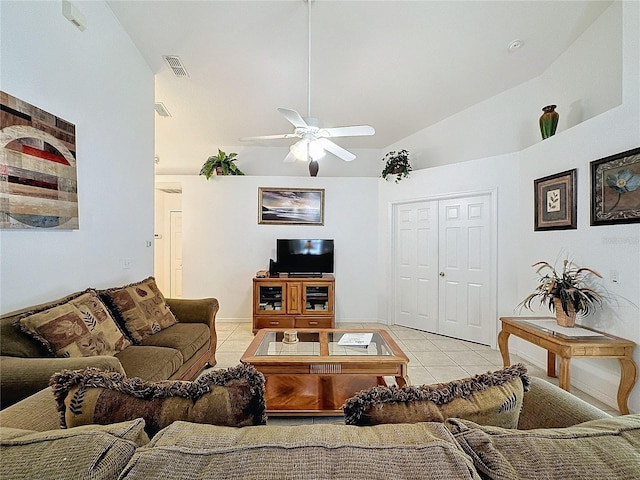 living room with ceiling fan, light tile patterned flooring, and vaulted ceiling