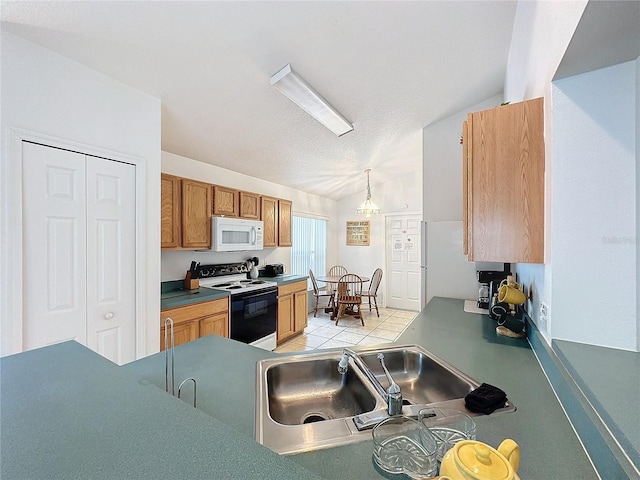 kitchen with white appliances, vaulted ceiling, sink, decorative light fixtures, and a chandelier