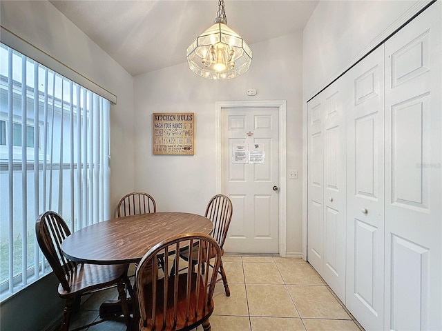 tiled dining area with a chandelier