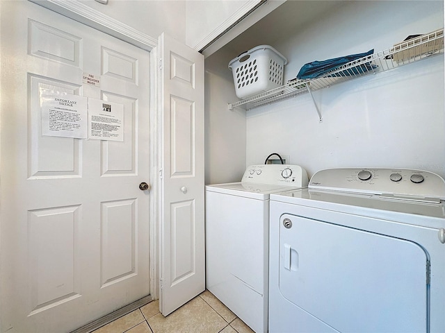 washroom featuring light tile patterned floors and separate washer and dryer