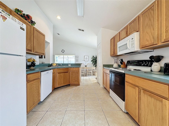 kitchen featuring kitchen peninsula, lofted ceiling, light tile patterned flooring, and white appliances