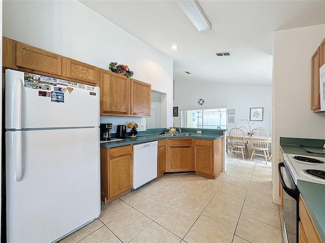 kitchen featuring light tile patterned flooring, white appliances, vaulted ceiling, and sink