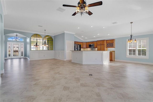 unfurnished living room featuring vaulted ceiling, crown molding, and ceiling fan with notable chandelier