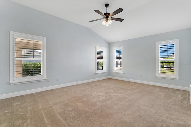 spare room with ceiling fan, light colored carpet, and lofted ceiling