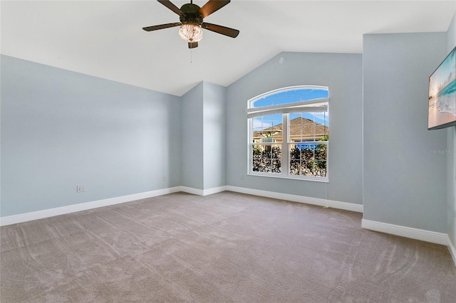 spare room with light carpet, ceiling fan, and lofted ceiling