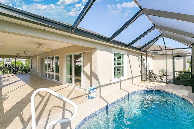 view of pool featuring a patio, ceiling fan, and glass enclosure