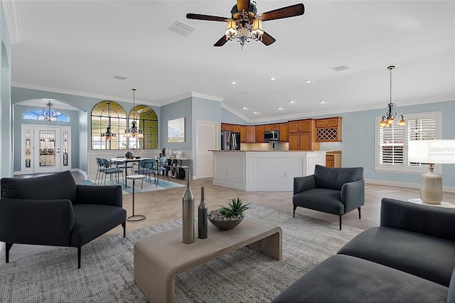 tiled living room with crown molding, ceiling fan with notable chandelier, and a healthy amount of sunlight