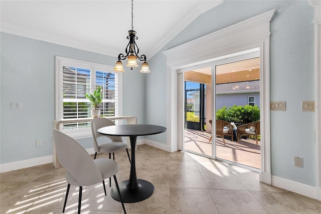 dining room featuring crown molding and vaulted ceiling