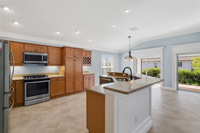 kitchen with sink, crown molding, a kitchen island with sink, hanging light fixtures, and stainless steel appliances