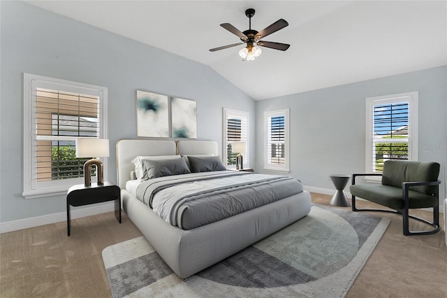 carpeted bedroom featuring lofted ceiling, multiple windows, and ceiling fan