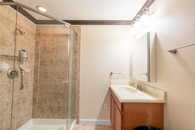 bathroom featuring vanity, a shower with shower door, and ornamental molding