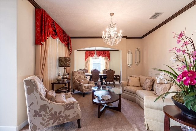 carpeted living room with a notable chandelier and ornamental molding