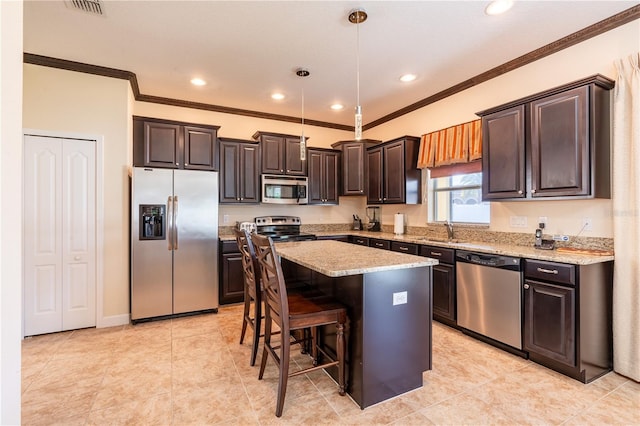 kitchen featuring sink, decorative light fixtures, a kitchen island, dark brown cabinetry, and stainless steel appliances