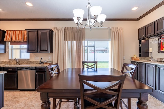 dining room with a notable chandelier, light tile patterned flooring, sink, and crown molding