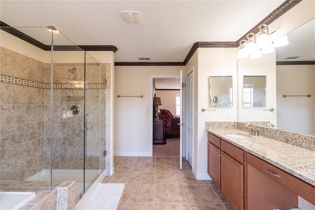 bathroom with tile patterned flooring, crown molding, a textured ceiling, vanity, and a shower with shower door