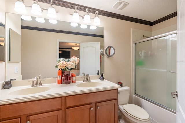 full bathroom featuring vanity, toilet, shower / bath combination with glass door, and crown molding