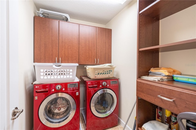 laundry area with cabinets, a textured ceiling, and independent washer and dryer