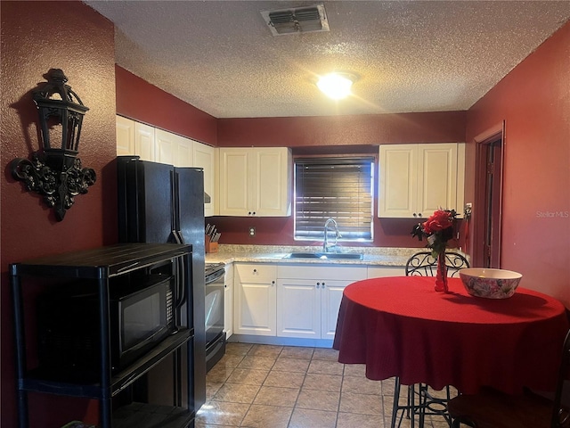 kitchen featuring white cabinets, black range with electric stovetop, and sink