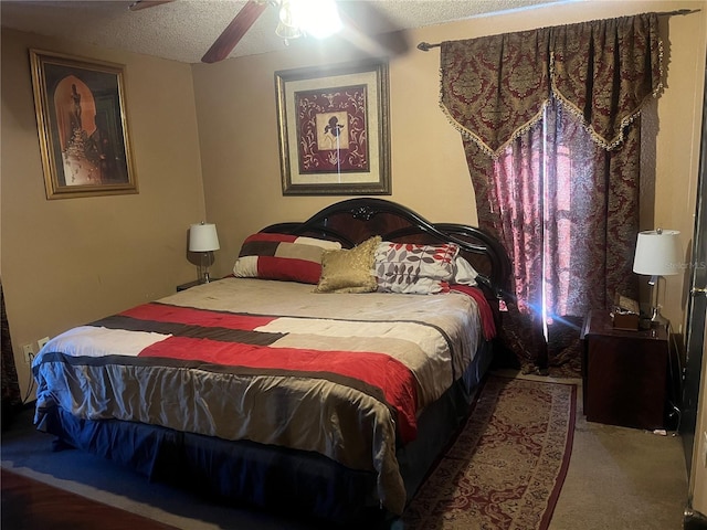 carpeted bedroom with ceiling fan and a textured ceiling