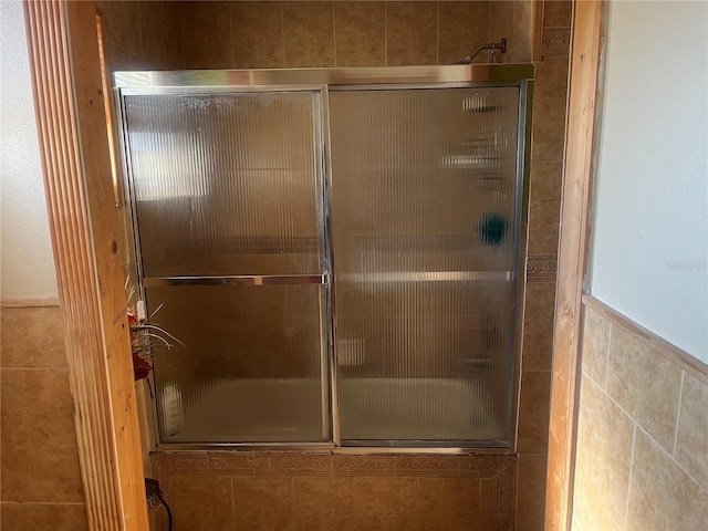 bathroom featuring bath / shower combo with glass door