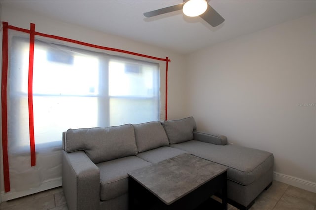 tiled living room with ceiling fan