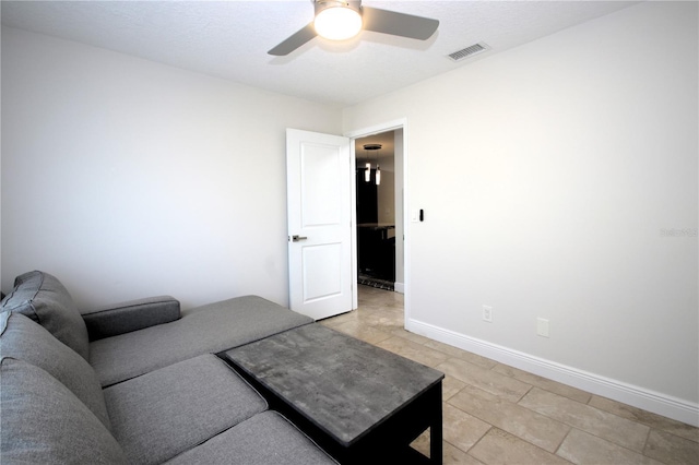 living room featuring ceiling fan and light tile patterned flooring