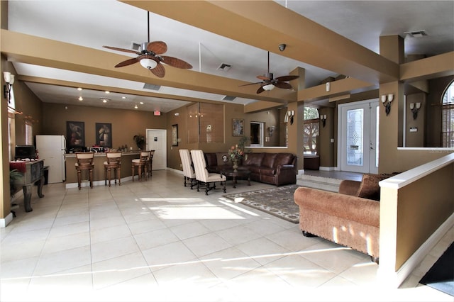 tiled living room with ceiling fan