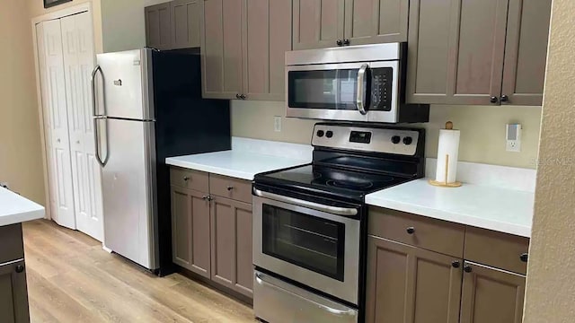 kitchen featuring light wood-type flooring and stainless steel appliances