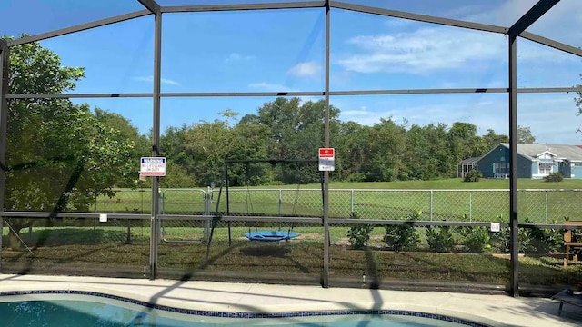 view of swimming pool with a lawn