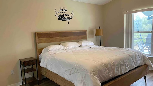 bedroom with hardwood / wood-style floors