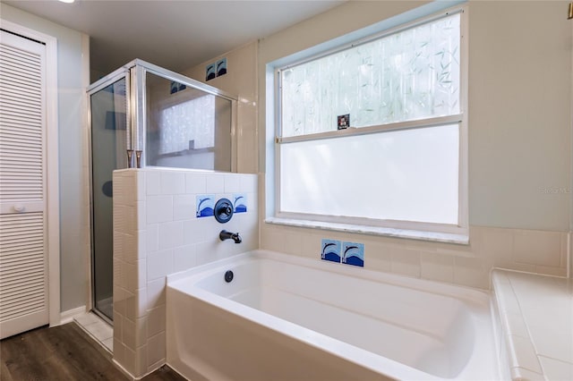 full bathroom with a garden tub and a shower stall