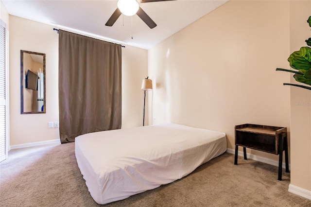 carpeted bedroom with baseboards and a ceiling fan